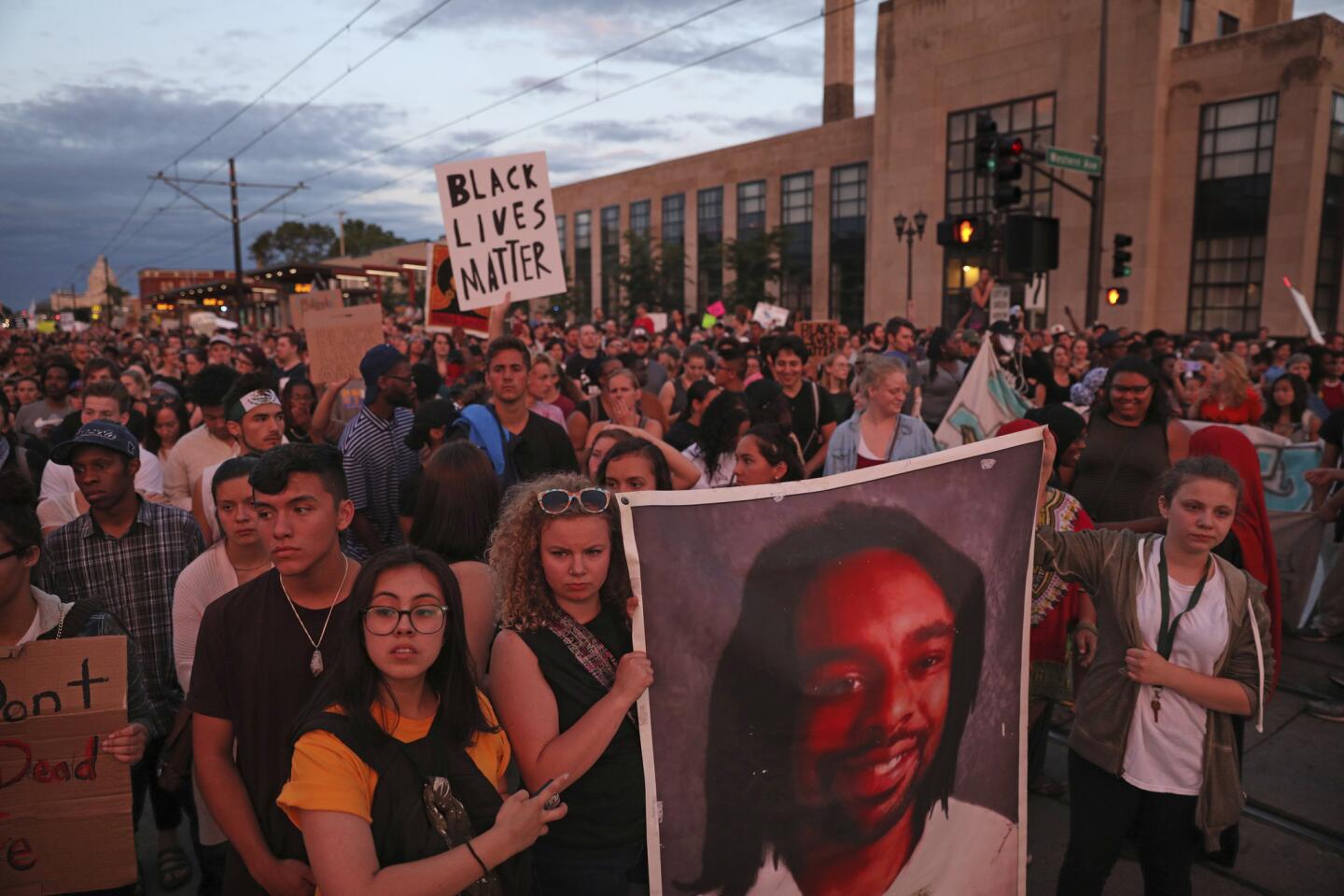Supporters of Philando Castile held a portrait of Castile as they marched along University Avenue in St. Paul, Minn., leaving a vigil at the state Capitol on Friday, June 16, 2017. The vigil was held after St. Anthony police Officer Jeronimo Yanez was cleared of all charges in the fatal shooting last year of Castile.