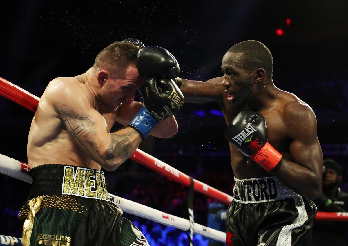 Terence Crawford punches Egidijus Kavaliauskas during their bout for Crawford's WBO welterweight title in 2019 