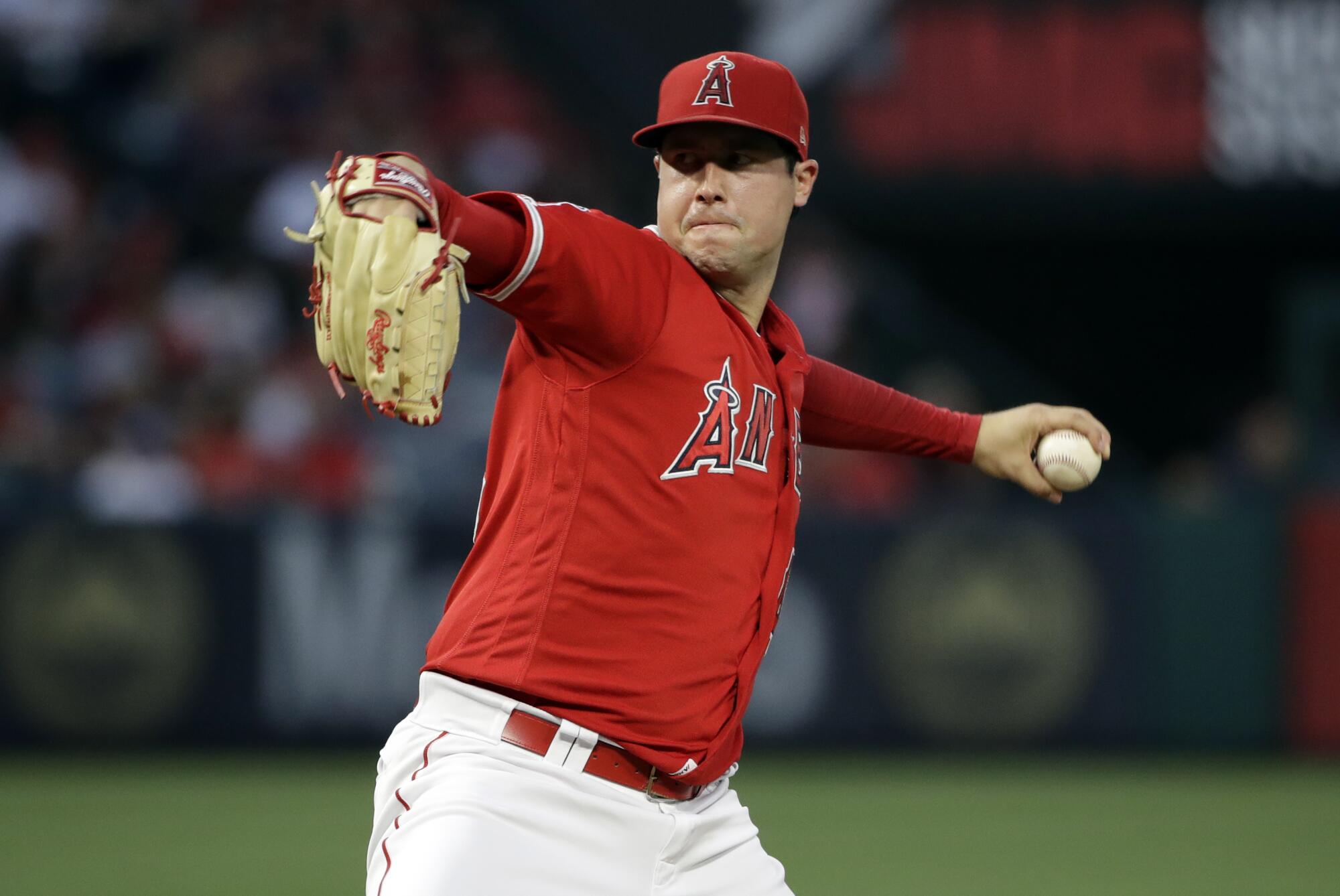 Angels left-hander Tyler Skaggs pitches with a red uniform and Rawlings baseball glove