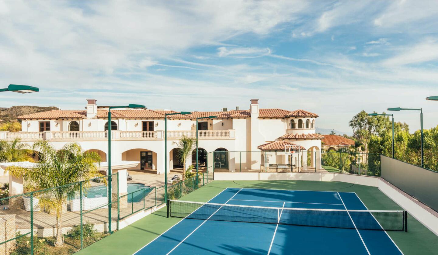 The 11,000-square-foot home comes with a pool, tennis court and custom garage with room for 14 cars.