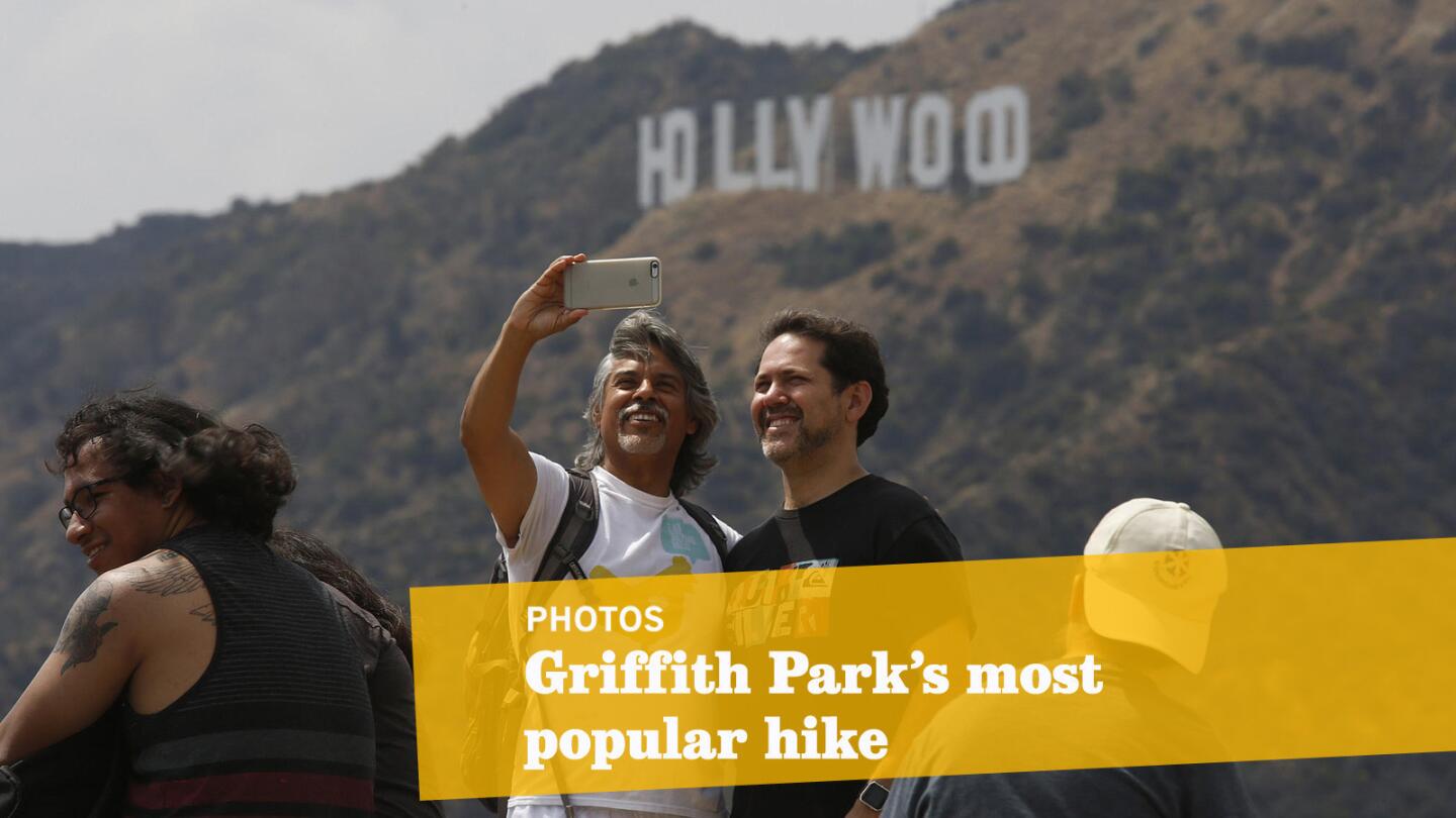 Sergio Jimenez, 46, and his boyfriend Ruben Garcia, 42, of Los Angeles, take a selfie with the Hollywood sign from the Tiffany & Co. Foundation Overlook.