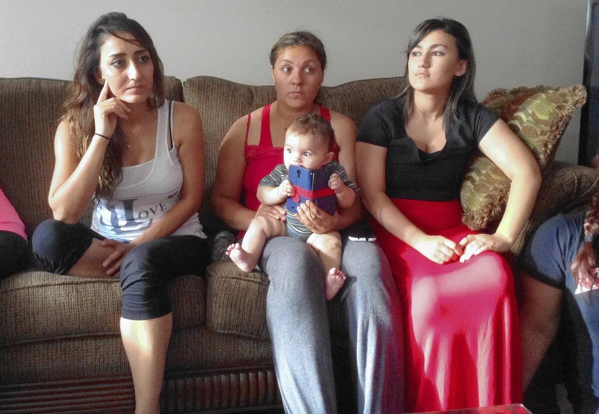 Mia Barakat, left, Sharifa Khalil and Shahnaz Osso in an apartment in Lincoln, Neb., with other Yazidis who are anxious about relatives in northern Iraq.