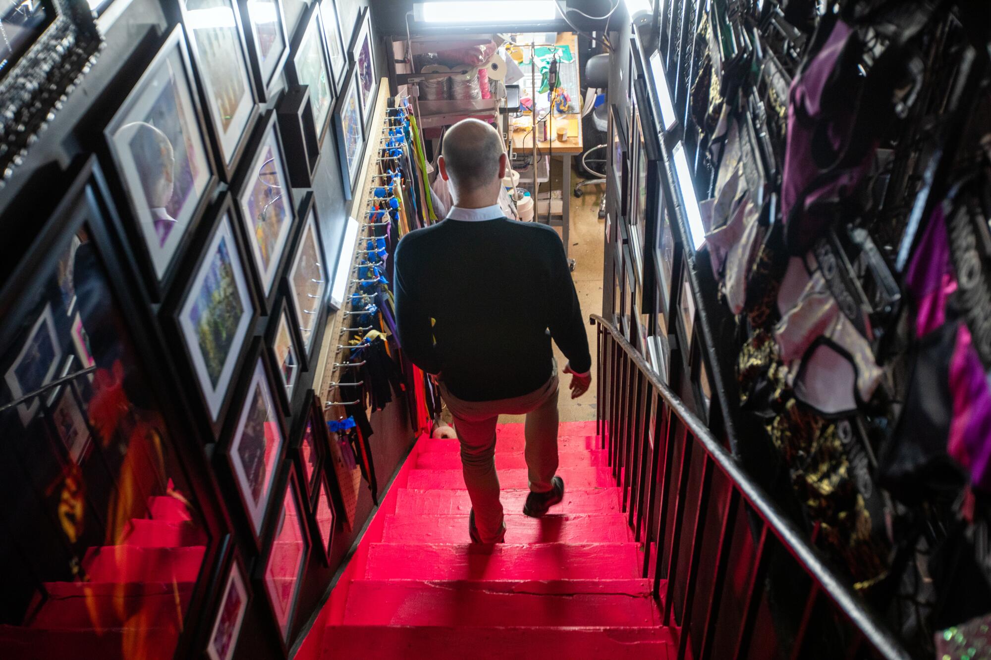 Chris Psaila, CEO of Marco Marco, walks down the stairs at his business.