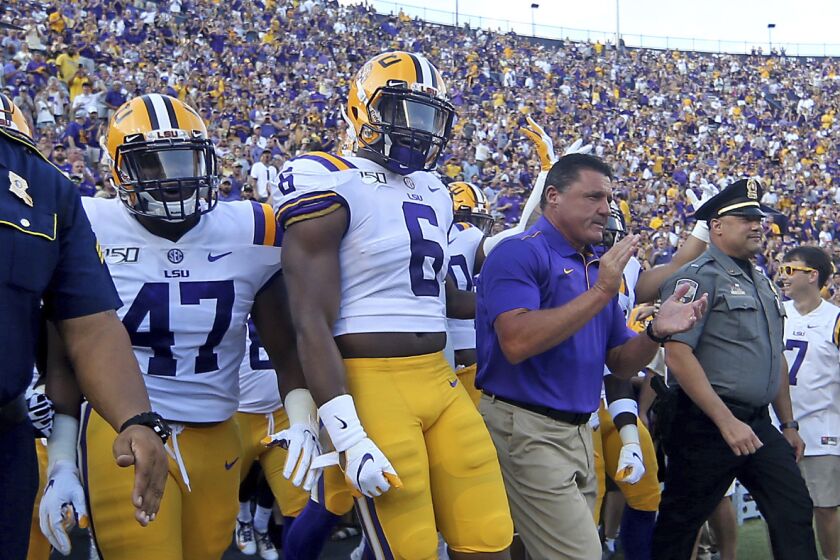 LSU Tigers head coach Ed Orgeron and the Tigers take the field during an NCAA football game between the Georgia Southern Eagles and Louisiana State University Tigers in Baton Rouge, La., Saturday, Aug. 31, 2019. (AP Photo/Michael Democker)