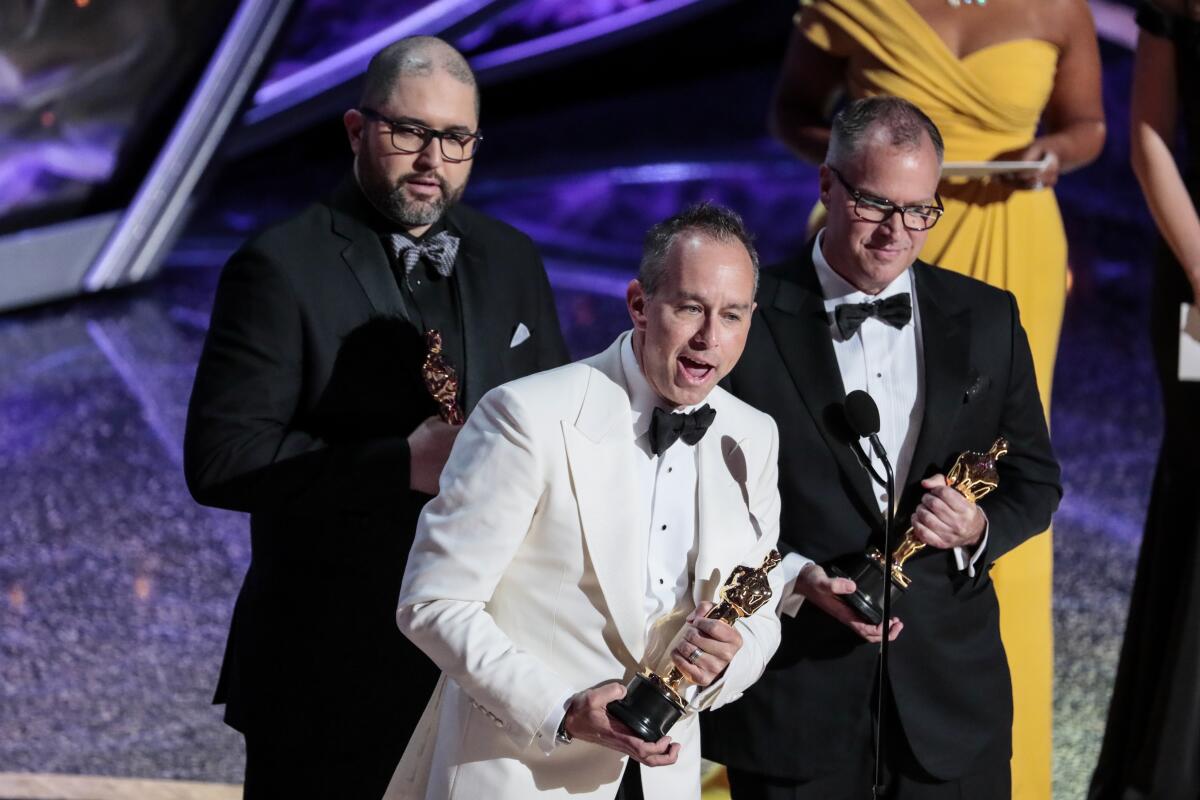 Left to right: Jonas Rivera, Josh Cooley and Mark Nielsen accept the Oscar for animated feature for “Toy Story 4."