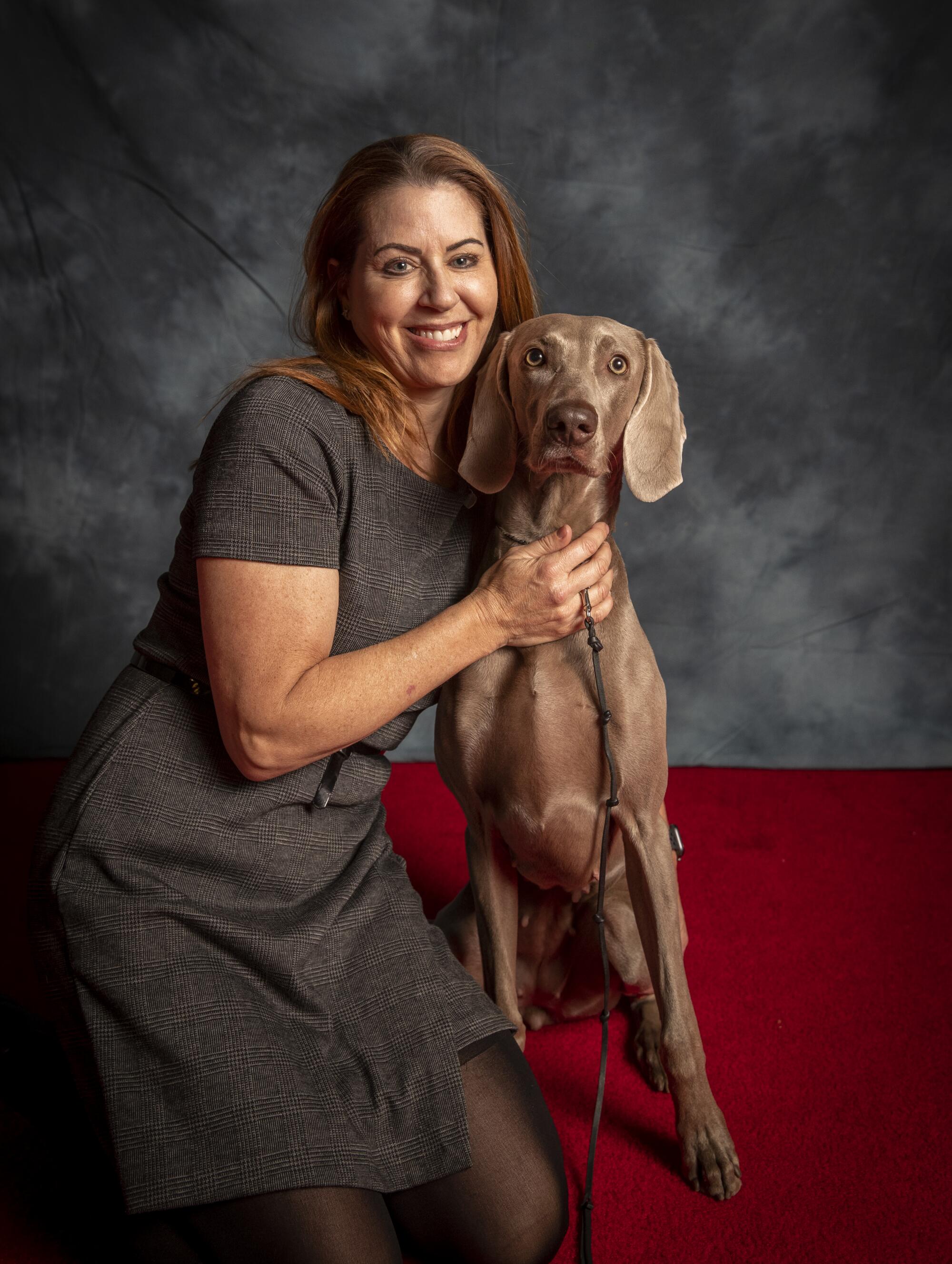 Tammy Basile of Capistrano, poses with 3-year-old Mandy, a Weimaraner