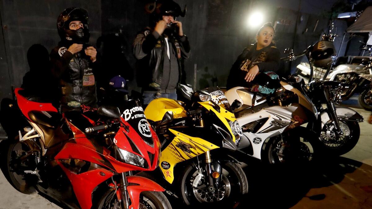 Members of the International Brotherhood of Street Racers hang out at the L.A. Deuces Motorcycle Club's clubhouse in South L.A. on Dec. 7, 2017.