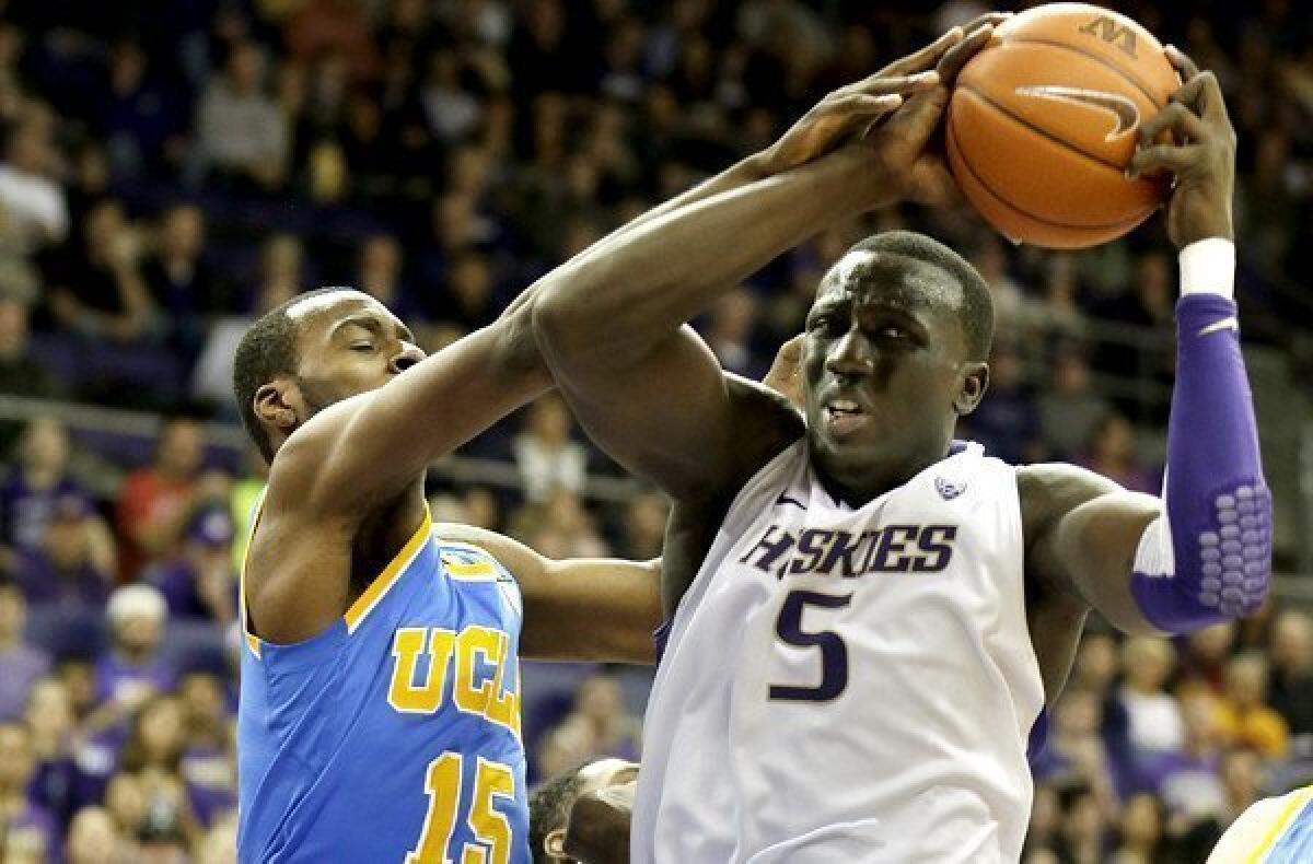 UCLA guard Shabazz Muhammad battles Washington center Aziz N'Diaye for a rebound in the first half Saturday.