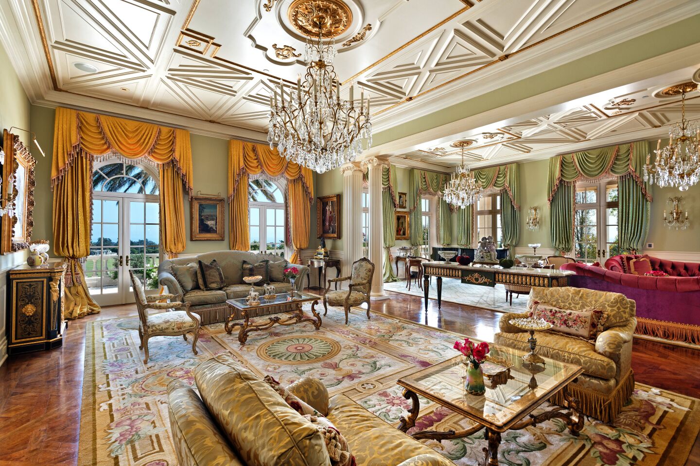 The mansion is full of formal spaces with crystal chandeliers, intricate ceilings, oversize drapes and mahogany finishes.