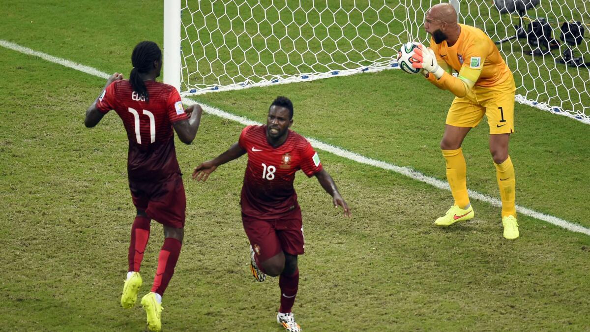 U.S. goalkeeper Tim Howard, right, reacts after a goal scored by Portugal's Silvestre Varela, center, as Portugal's Eder celebrates in the closing seconds of a 2-2 draw in Group G play at the World Cup on Sunday.