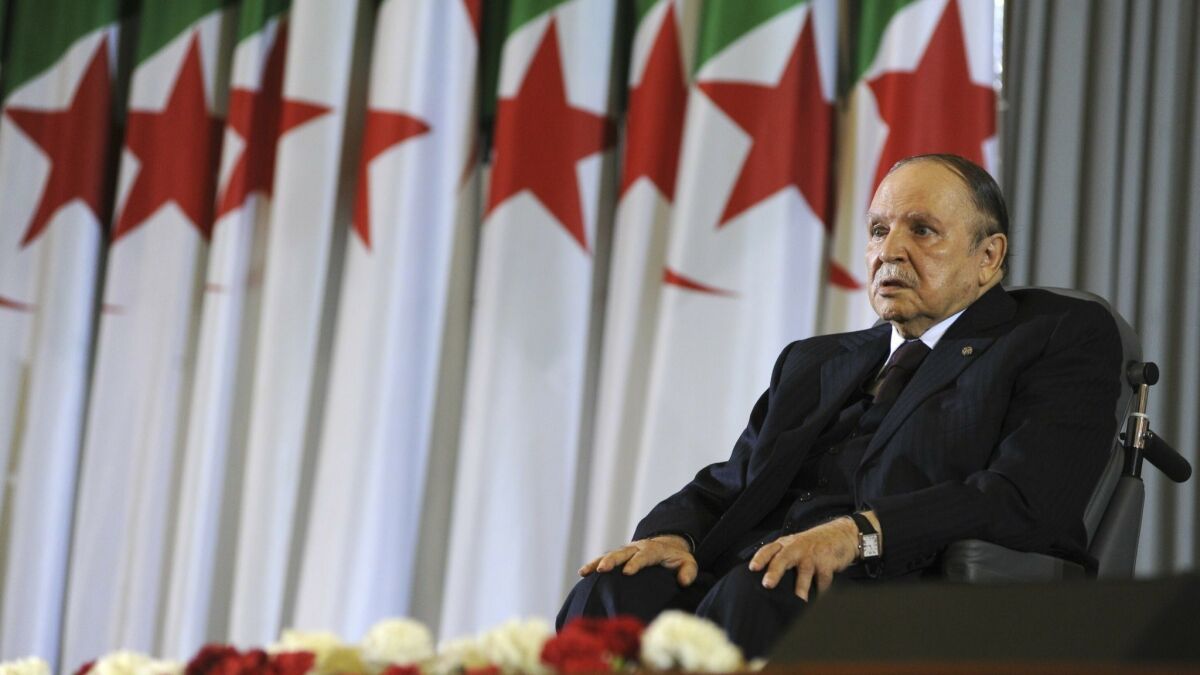 In this April 28, 2014, photo, Algerian President Abdelaziz Bouteflika sits in a wheelchair after taking the oath as president, in Algiers, Algeria.