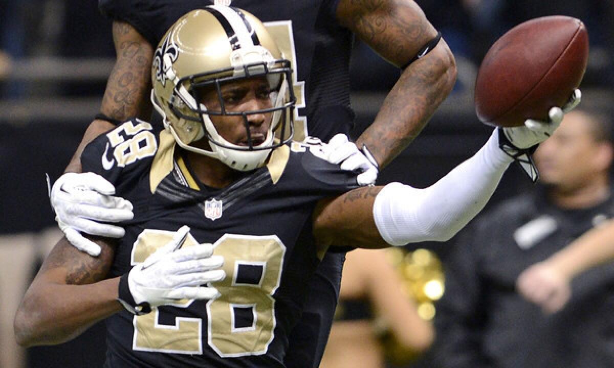 New Orleans Saints cornerback Keenan Lewis celebrates an interception against the Tampa Bay Buccaneers on Dec. 29. Lewis was one of two players who violated NFL concussion protocol during last weekend's playoffs games, the Associated Press reports.