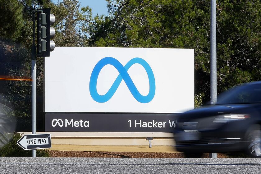 FILE - A car passes Facebook's new Meta logo on a sign at the company headquarters, on Oct. 28, 2021, in Menlo Park, Calif. A Nigerian advertising regulator has sued Meta, accusing the owner of Facebook and WhatsApp of publishing unauthorized ads. (AP Photo/Tony Avelar, File)