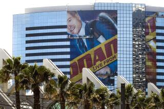 SAN DIEGO, July 13, 2018 | A building wrap for Conan O'Brien is put on the Marriott Marquis San Diego Marina in preparation for Comic Con in San Diego on Friday. | Photo by Hayne Palmour IV/San Diego Union-Tribune/Mandatory Credit: HAYNE PALMOUR IV/SAN DIEGO UNION-TRIBUNE/ZUMA PRESS San Diego Union-Tribune Photo by Hayne Palmour IV copyright 2018