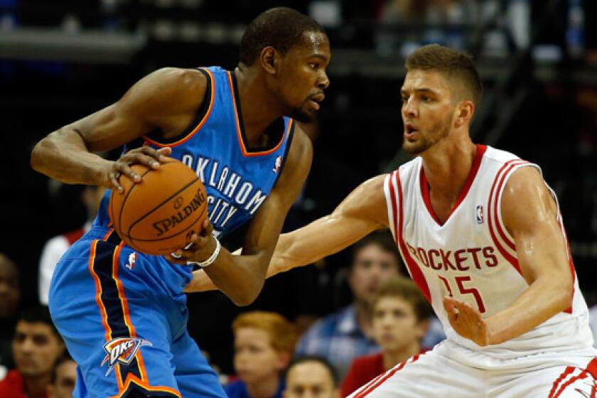 Oklahoma City Thunder forward Kevin Durant, left, tries to drive past Houston Rockets forward Chandler Parsons during an April 4 game. Durant is making a strong case to win the NBA's MVP award this season.