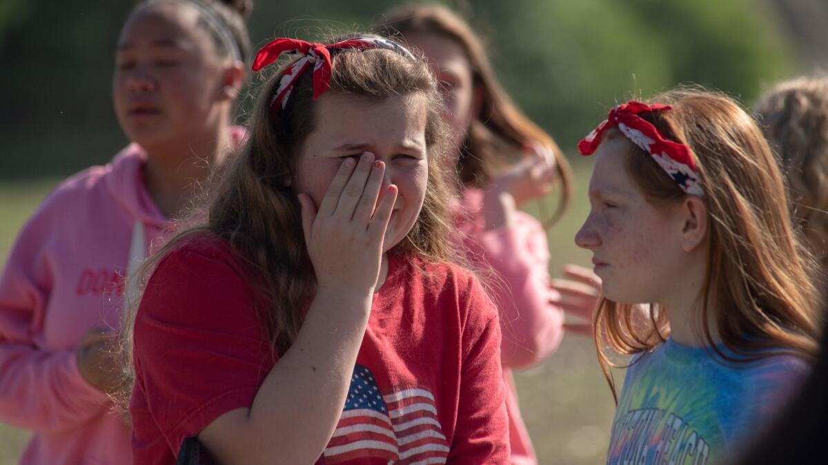 Students react outside Noblesville West Middle School after a shooting Friday in Noblesville, Ind.