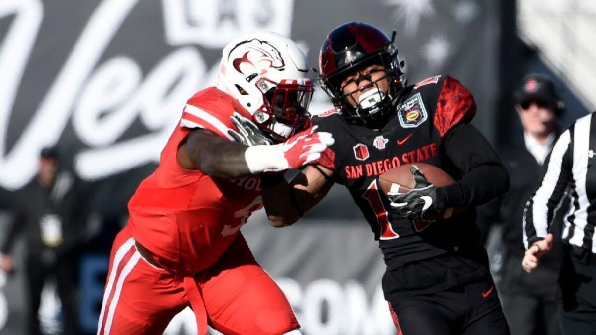 San Diego State running back Donnel Pumphrey rushes against Houston linebacker Matthew Adams during the first half of the Las Vegas Bowl on Dec. 17.