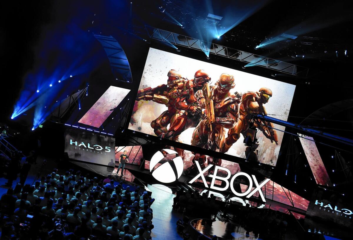 The audience watches a preview of the "Halo 5: Guardians" video game during Microsoft's Xbox media briefing before the opening of the Electronic Entertainment Expo at the Los Angeles Convention Center.
