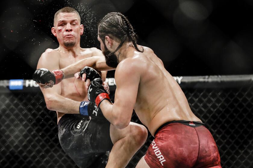 Jorge Masvidal, right, punches Nate Diaz during the third round of a welterweight mixed martial arts bout at UFC 244 Sunday, Nov. 3, 2019, in New York. Masvidal won in the fourth round. (AP Photo/Frank Franklin II)