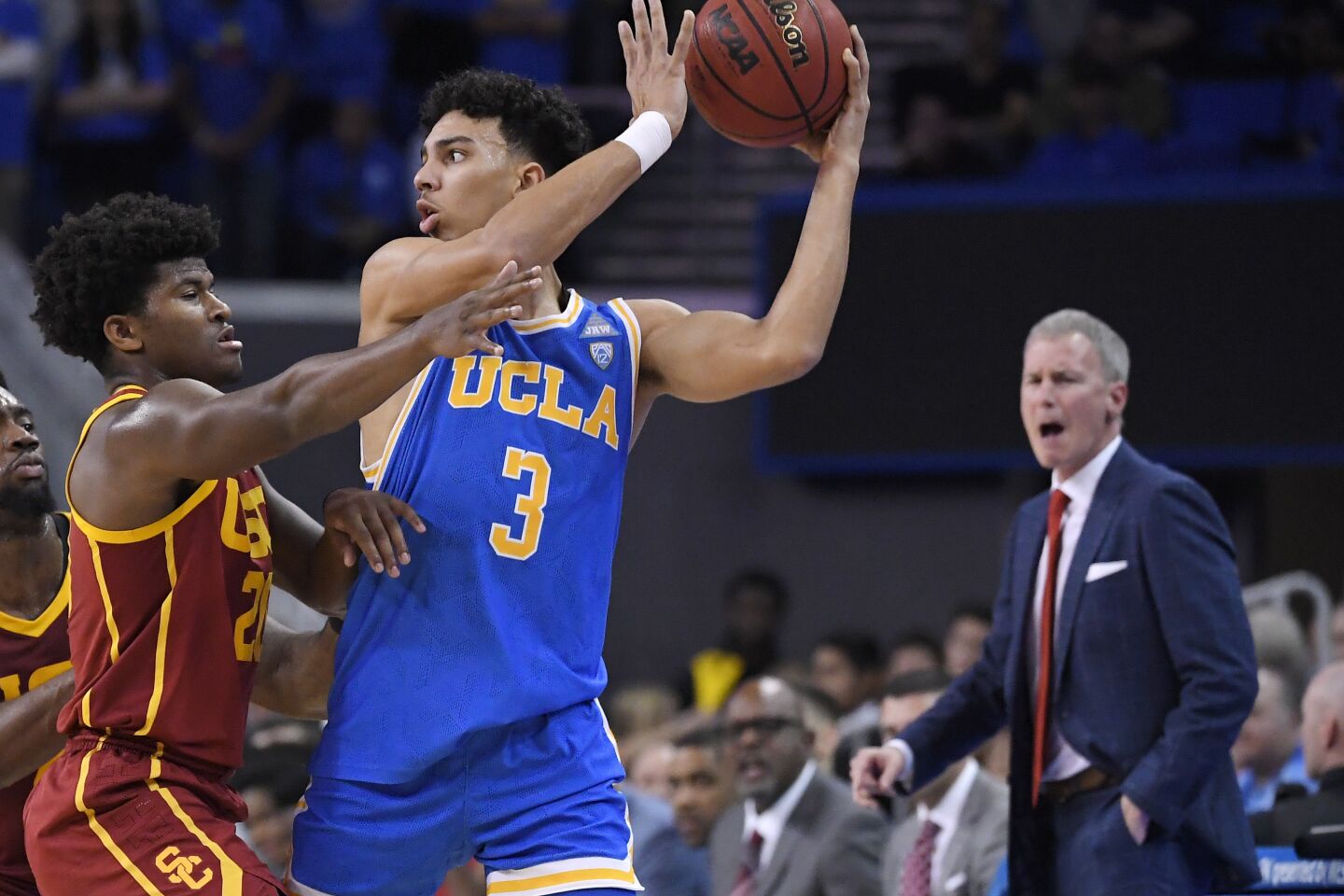 UCLA guard Jules Bernard looks to pass while being defended by USC guard Ethan Anderson during a game Jan. 11 at Pauley Pavilion.