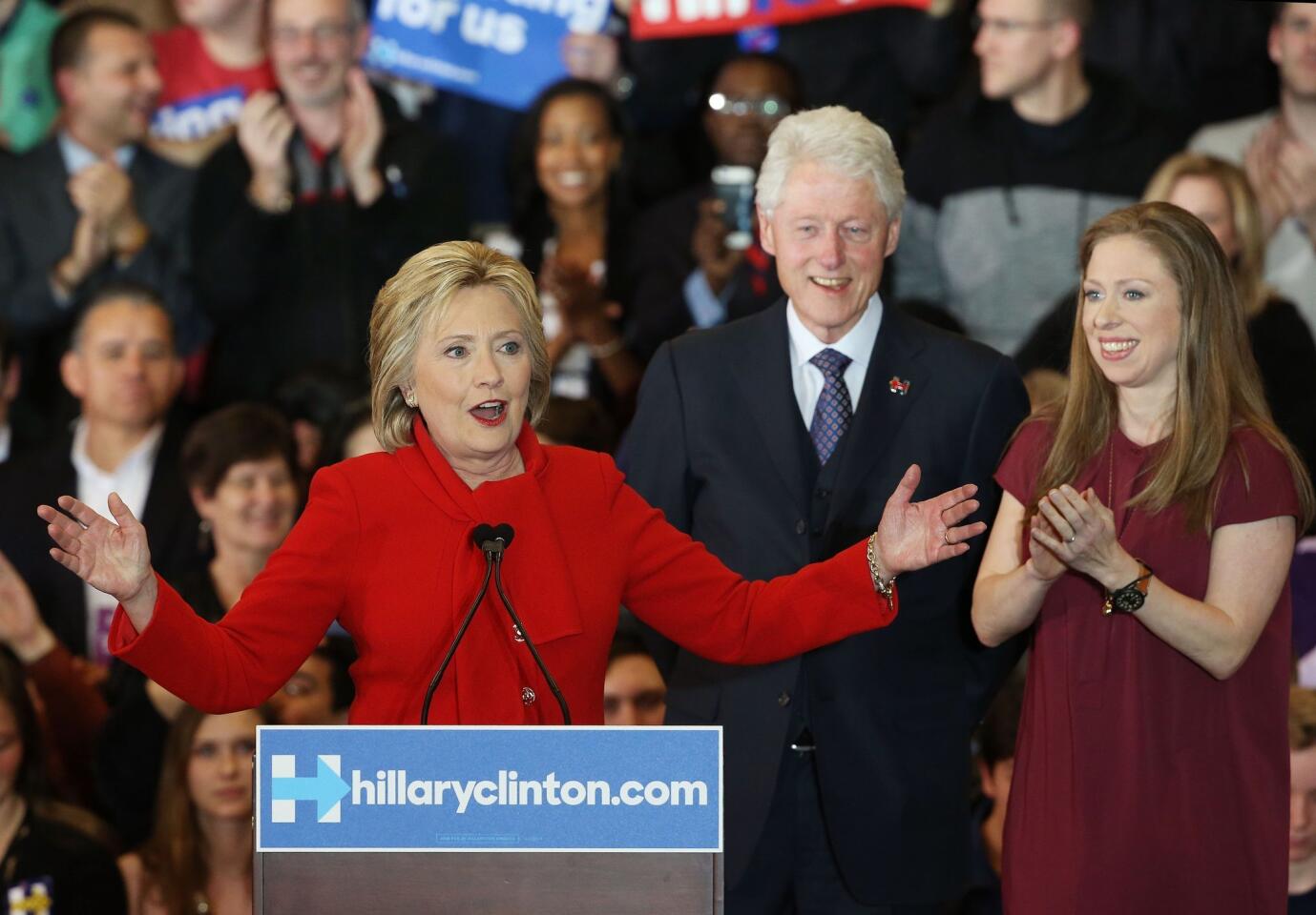Democratic presidential candidate former Secretary of State Hillary Clinton speaks to supporters as Former U.S. president Bill Clinton and daughter Chelsea Clinton look on during her caucus night event in the Olmsted Center at Drake University in Des Moines, Iowa.