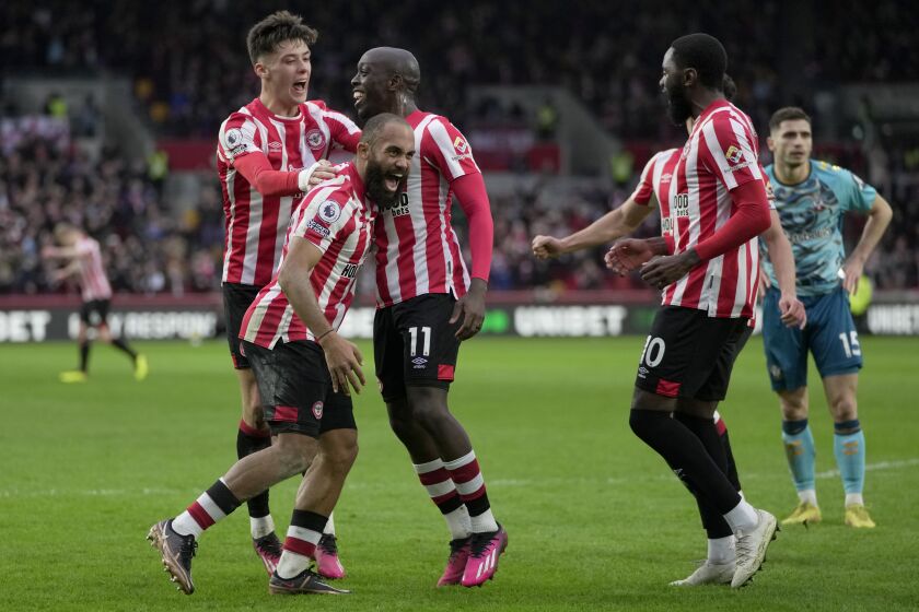 Brentford's Bryan Mbeumo,foreground left, celebrates after scoring his side's second goal during the English Premier League soccer match between Brentford and Southampton at Brentford Community Stadium in London, Saturday, Feb. 4, 2023. (AP Photo/Kin Cheung)