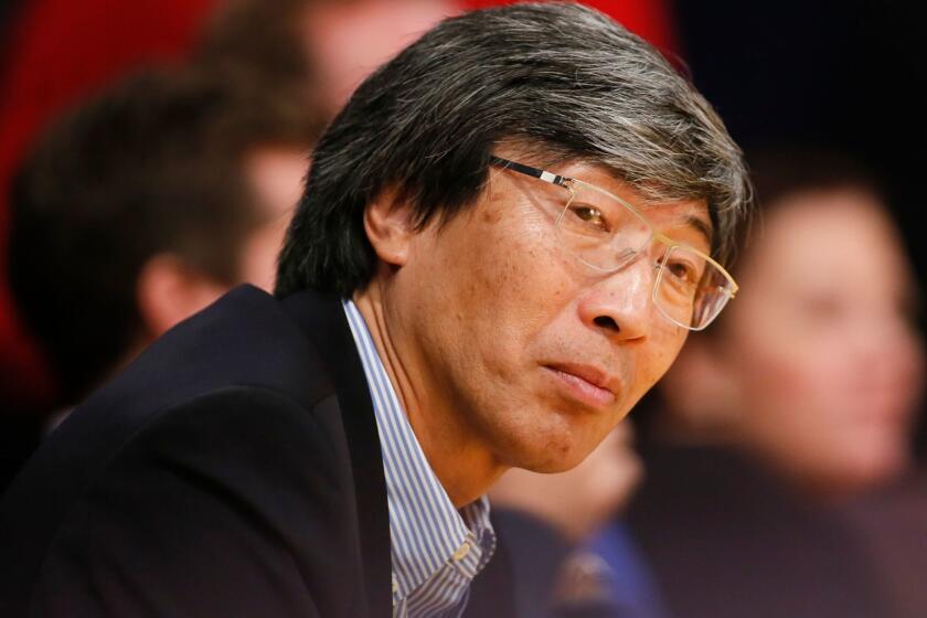 Dr. Patrick Soon-Shiong sits courtside as the Los Angeles Lakers play against the Utah Jazz during the second half of an NBA basketball game in Los Angeles, Tuesday, Feb. 11, 2014. The Jazz won 96-79. (AP Photo/Danny Moloshok)