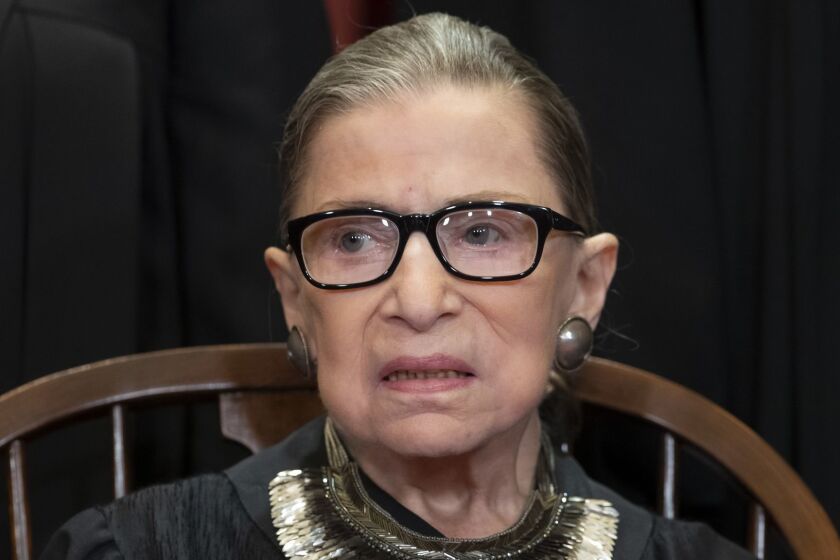FILE - In this Nov. 30, 2018 file photo, Associate Justice Ruth Bader Ginsburg, nominated by President Bill Clinton, sits with fellow Supreme Court justices for a group portrait at the Supreme Court Building in Washington. Ginsburg is making her first public appearance since undergoing lung cancer surgery in December. The 85-year-old Ginsburg is attending a concert at a museum a few blocks from the White House that is being given by her daughter-in-law and other musicians. Patrice Michaels is married to Ginsburg's son, James. Michaels is a soprano and composer. (AP Photo/J. Scott Applewhite, File)