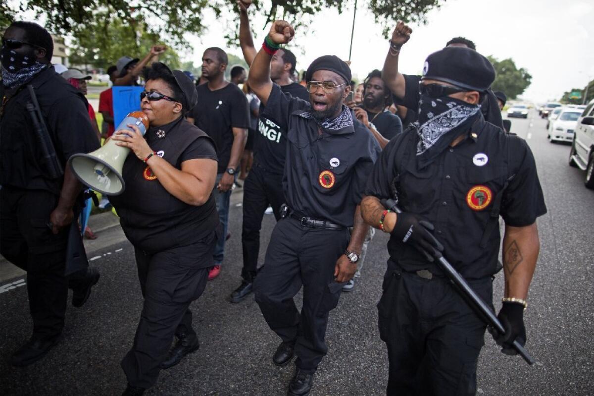 Members of the New Black Panther Party march in front of the Baton Rouge Police Department headquarters in support of justice for Alton Sterling, who was killed by police on July 9 in Baton Rouge, La.