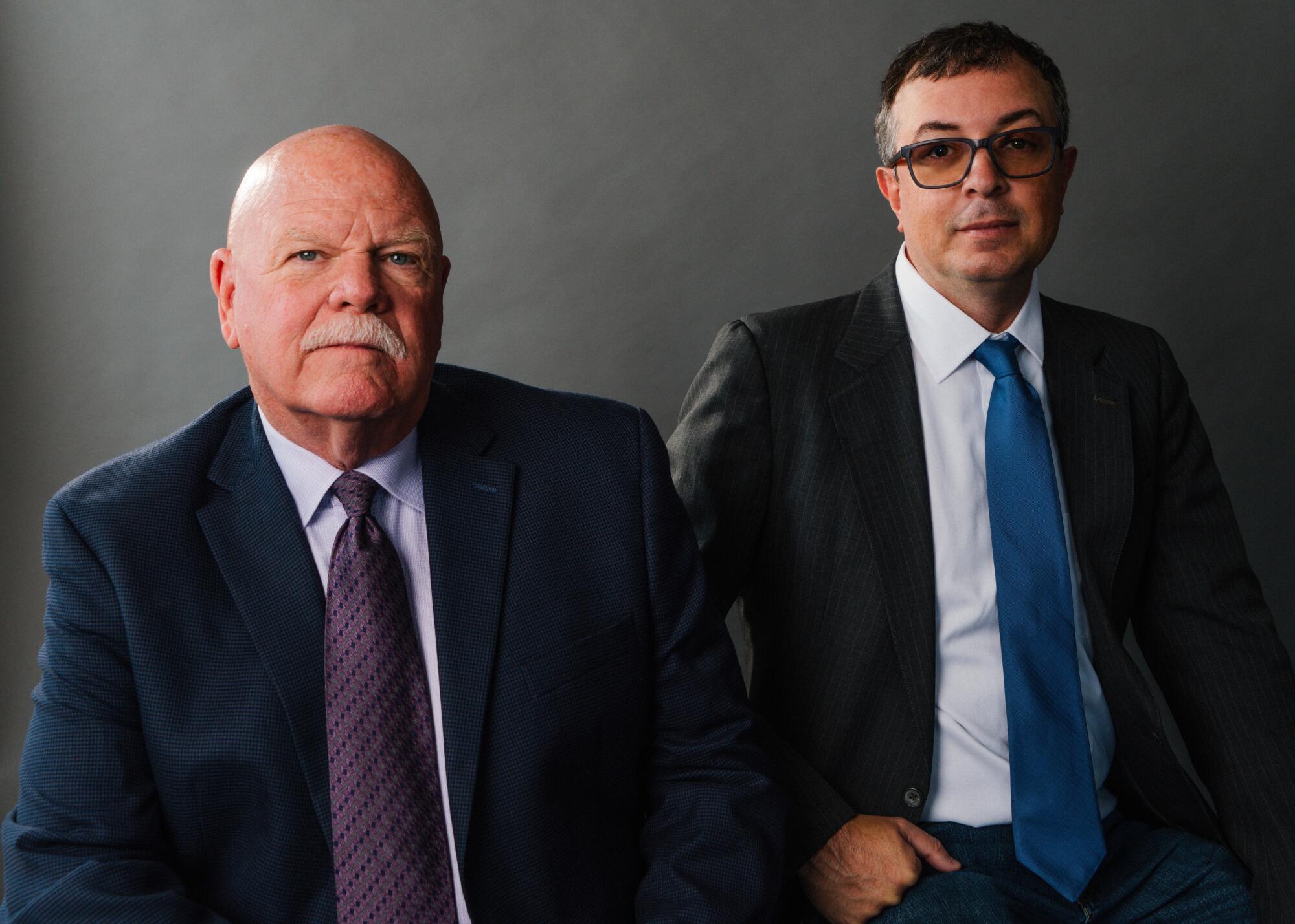 Rick Jackson and Matthew McGough, in dark suits.