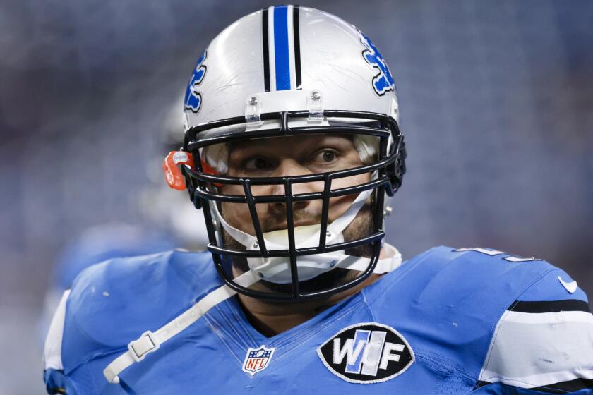 Detroit Lions center Dominic Raiola warms up before a game against the Minnesota Vikings on Dec. 14.