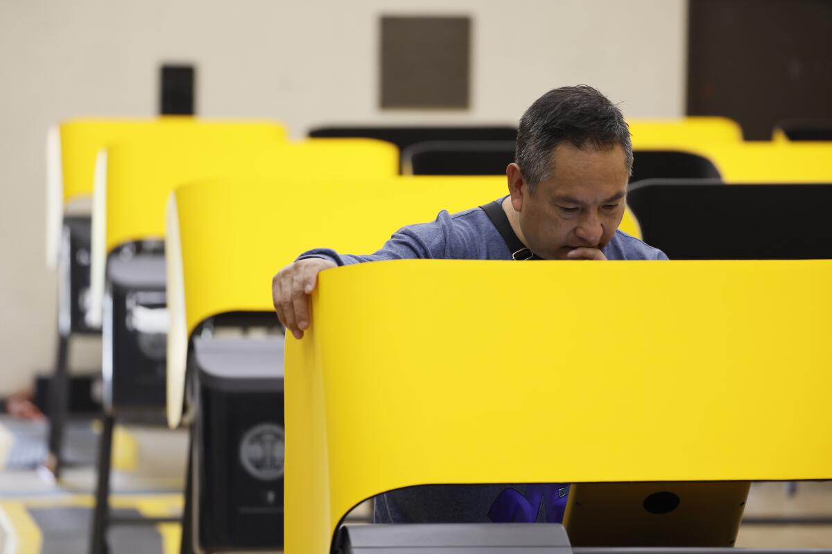 A voter casts his ballot at a vote center in Boyle Heights on March 5. 