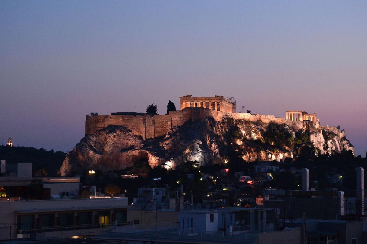 Athens' Acropolis illuminated at night looks tranquil, but Greece continues to be in turmoil over its financial situation.