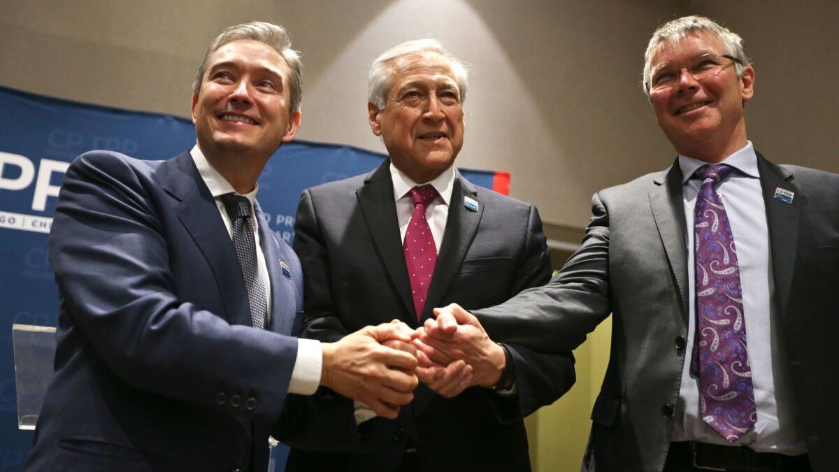Francois-Philippe Champagne of Canada, Heraldo Munoz of Chile and David Parker of New Zealand in Santiago, Chile, before a signing ceremony for the Comprehensive and Progressive Trans-Pacific Partnership.
