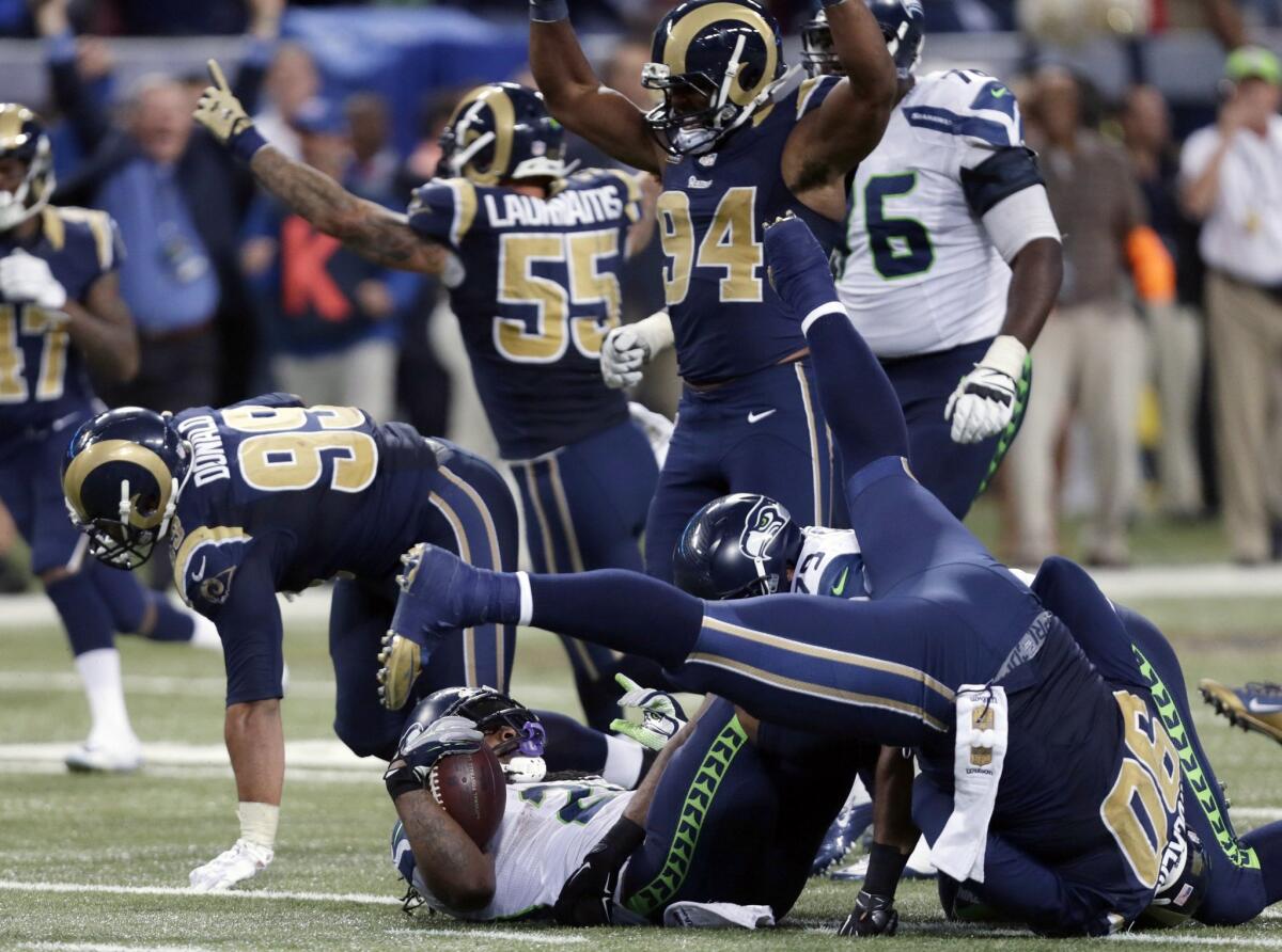Seattle running back Marshawn Lynch is stopped on fourth down in overtime Sunday against St. Louis.
