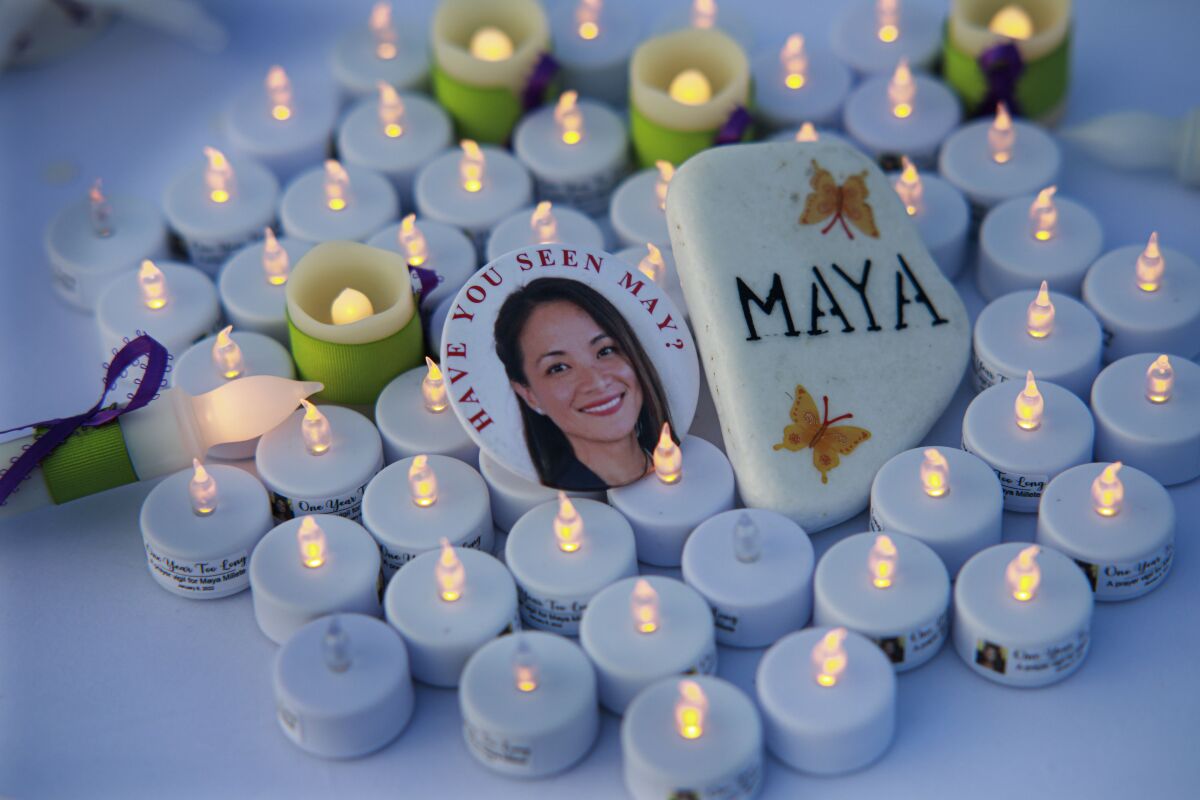 Button and candles at a prayer vigil in Chula Vista for May "Maya" Millete on Jan. 8, 2022.