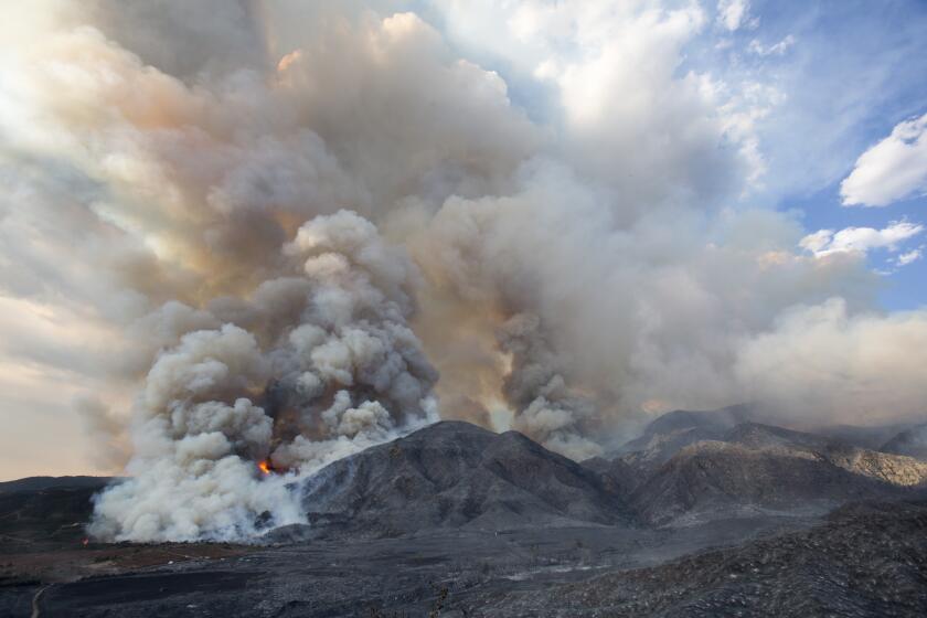 Smoke rises from a wildfire burning at a hillside in Yucaipa, Calif., Saturday, Sept. 5, 2020. Three fast-spreading wildfires sent people fleeing and trapped campers in one campground as a brutal heat wave pushed temperatures above 100 degrees in many parts of California. (AP Photo/Ringo H.W. Chiu)