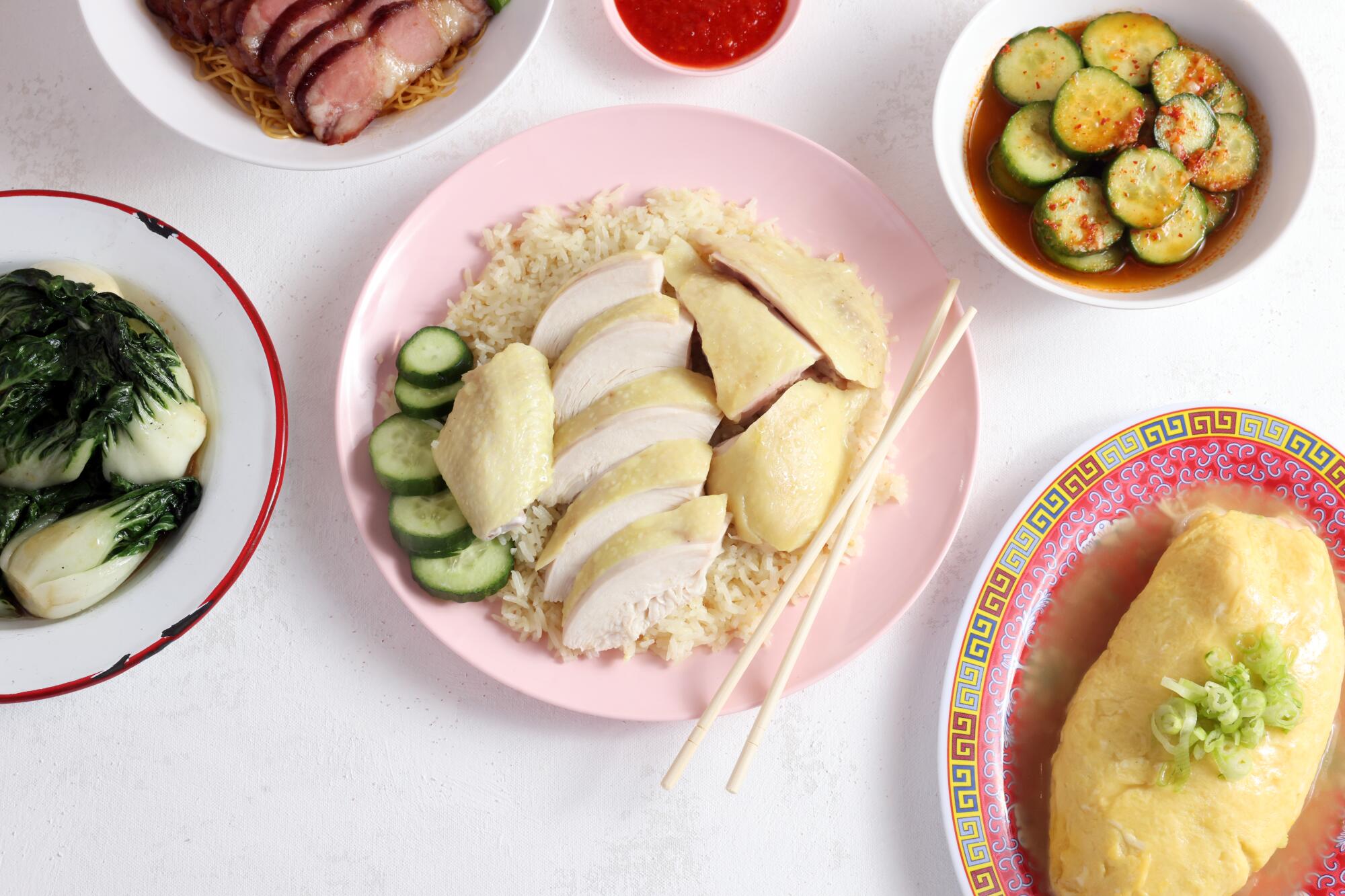 Overhead shot of chicken and rice and several other dishes 