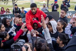 PALMDALE, CALIF. -- SUNDAY, DECEMBER 29, 2019: LA Clippers forward Paul George greets young fans.