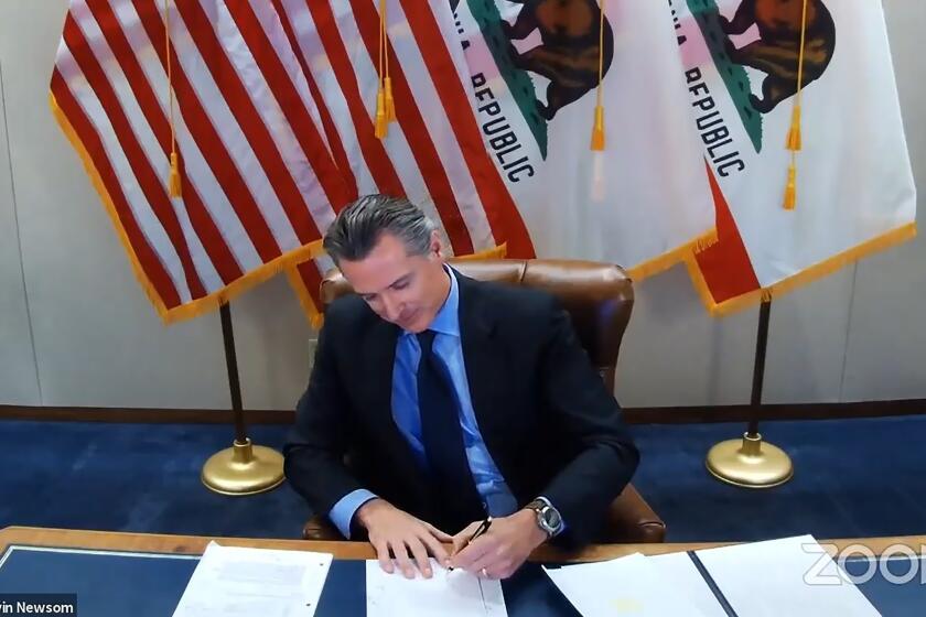 FILE - In this image made from video from the Office of the Governor California Gov. Gavin Newsom signs into law a bill that establishes a task force to come up with recommendations on how to give reparations to Black Americans on Sept. 30, 2020, in Sacramento, Calif. A report by California's first in the nation task force on reparations Wednesday, June 1, 2022, will document in detail the harms perpetuated by the state against Black people and recommend ways to address those wrongs. (Office of the Governor via AP, File)