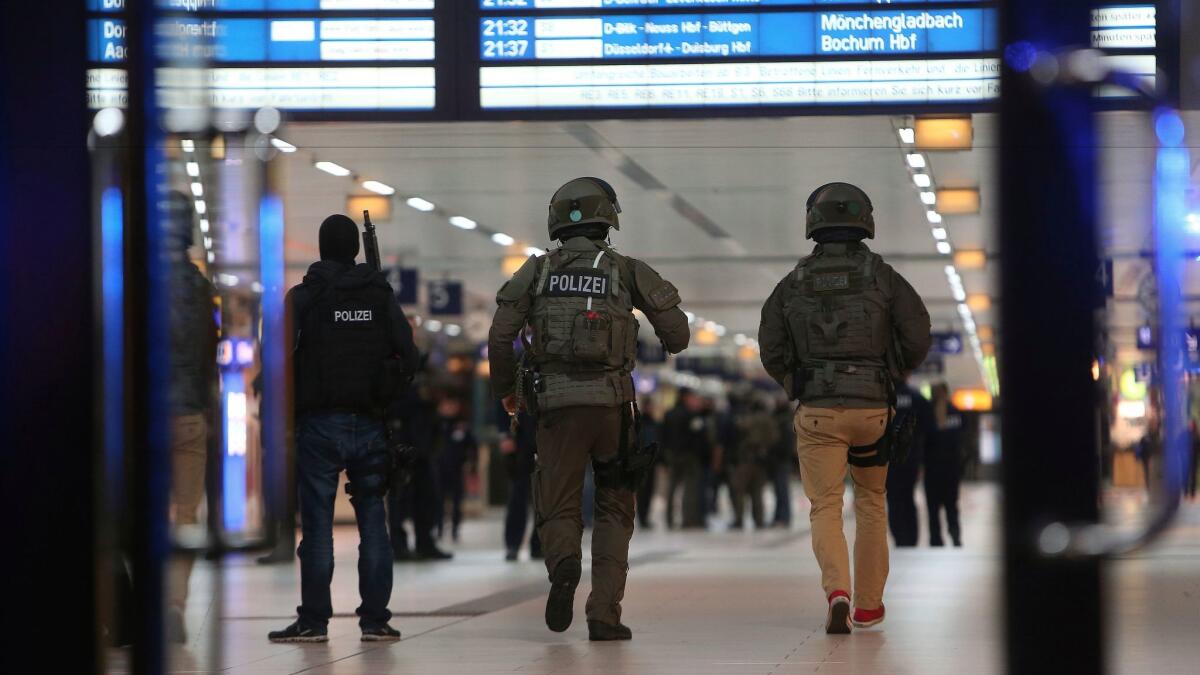 Special police forces walk in the main train station in Duesseldorf, western Germany, on Thursday after an ax attack.