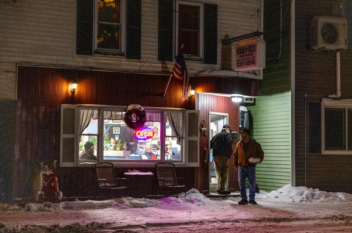 Patrons leave the House of Pizza on a frigid winter night in rural northern New Hampshire.