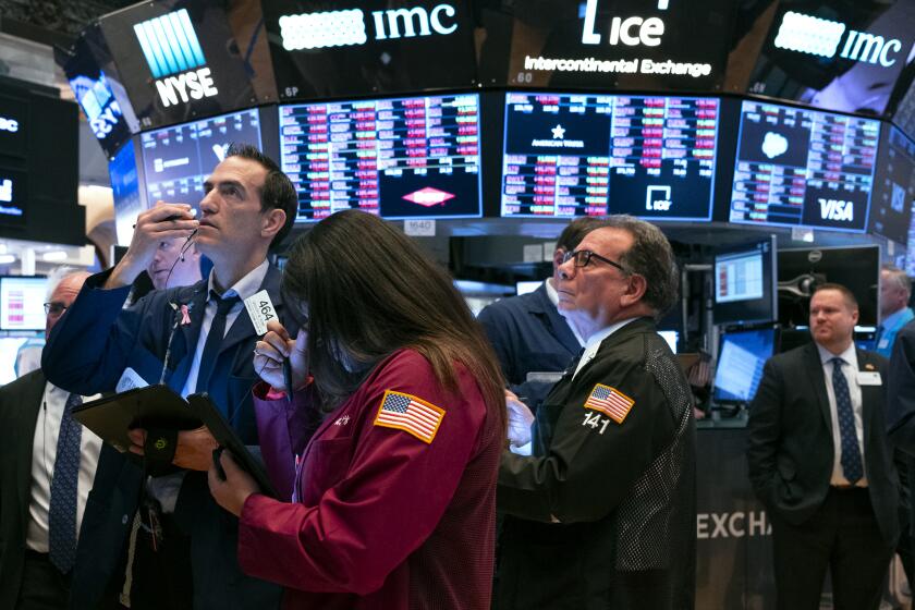 Traders work on the floor of the New York Stock Exchange Monday, March 16, 2020. Stocks lost 8% in morning trading on Wall Street Monday as huge swaths of the economy come closer to shutting down due to the coronavirus outbreak. (AP Photo/Craig Ruttle)