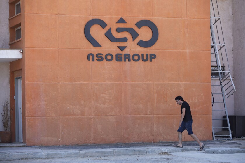 FILE - A logo adorns a wall on a branch of the Israeli NSO Group company, near the southern Israeli town of Sapir, Aug. 24, 2021. Israel’s Defense Ministry said in a statement Monday, Dec. 6, 2021, that it is tightening supervision over cyber exports — a move that follows a series of scandals involving Israeli spyware company NSO Group. The ministry said the countries purchasing Israeli cyber technology would have to sign a declaration pledging to use the products “for the investigation and prevention of terrorist acts and serious crimes only.” (AP Photo/Sebastian Scheiner, File)