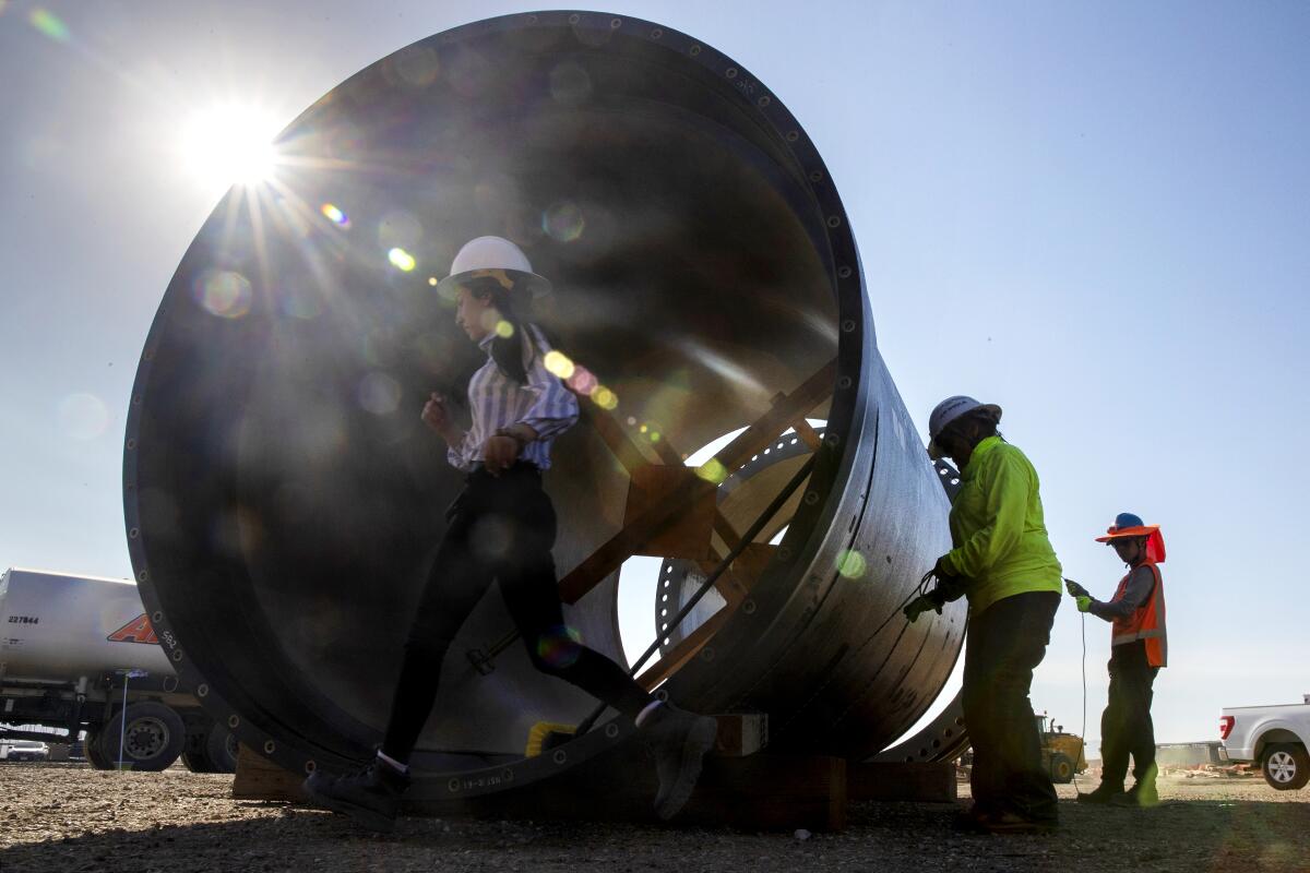 Crews work on a portion of a 104-inch diameter earthquake-resistant ductile iron pipe on the Colorado River Aqueduct