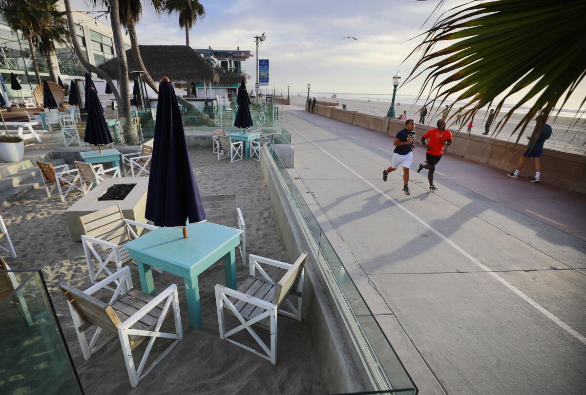 Tables sit empty at the Beach House Grill in Mission Beach on Monday, Dec. 7, 2020.