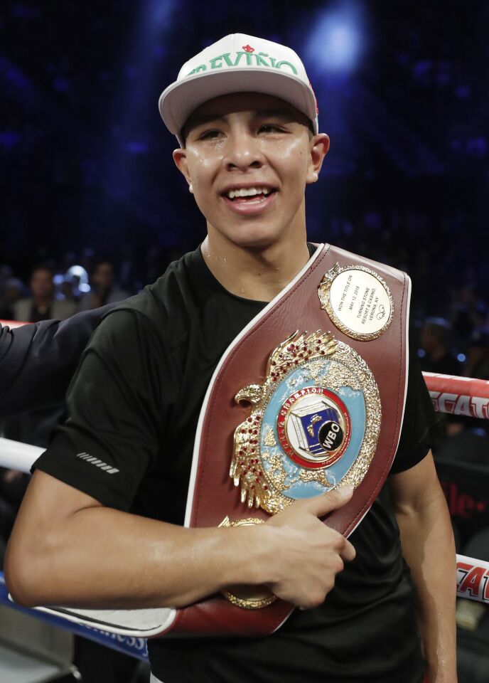 Jaime Munguia celebrates his third-round TKO victory over Brandon Cook following their WBO junior middleweight championship boxing match, Saturday, Sept. 15, 2018, in Las Vegas.
