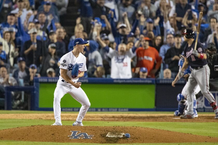 LOS ANGELES, CA - OCTOBER 9, 2019: Los Angeles Dodgers starting pitcher Walker Buehler (21) reacts after striking out Washington Nationals first baseman Ryan Zimmerman (11) in the 6th inning of Game 5 of the NLDS at Dodger Stadium on October 9, 2019 in Los Angeles, California. (Gina Ferazzi/Los AngelesTimes)