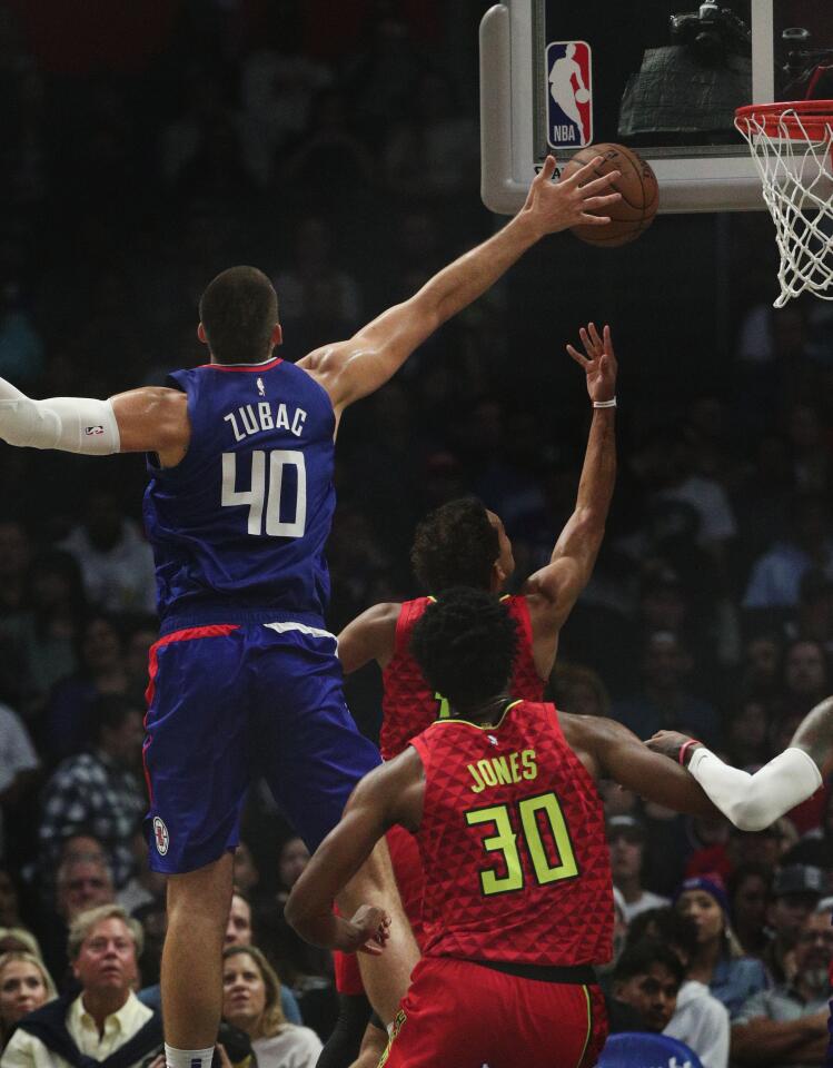 Clippers center Ivica Zubac tries to block a shot by Atlanta Hawks guard Trae Young.
