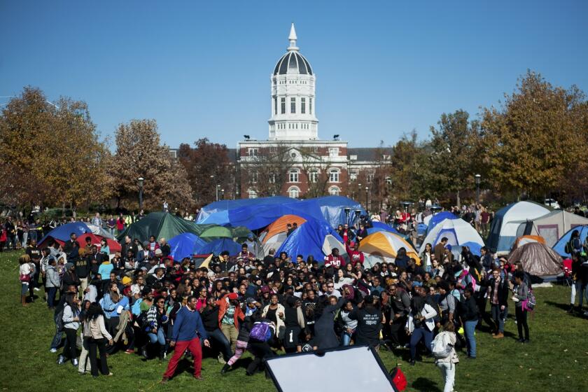 Supporters of Concerned Student 1950 celebrate University of Missouri System President Tim Wolfe's resignation announcement in Columbia, Mo.